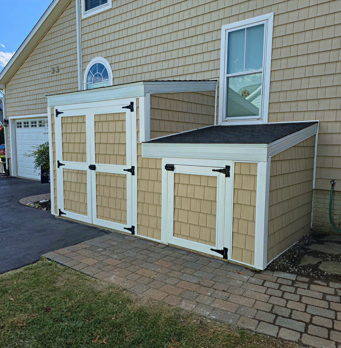 Dual-door shed beside a house