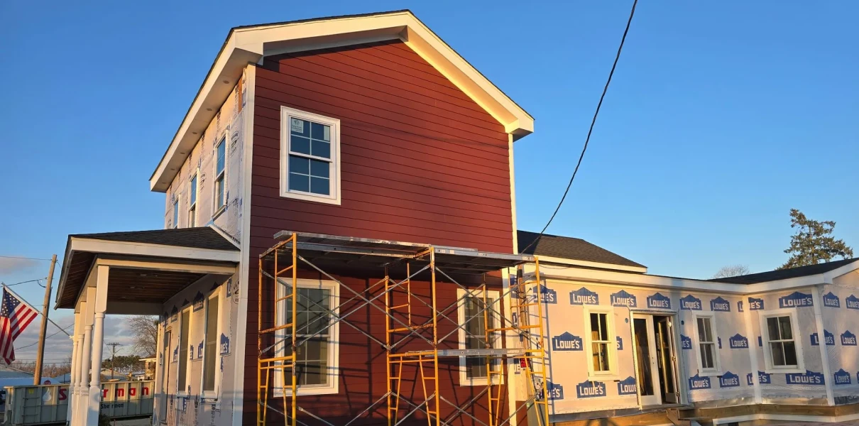 Red house under construction with scaffolding